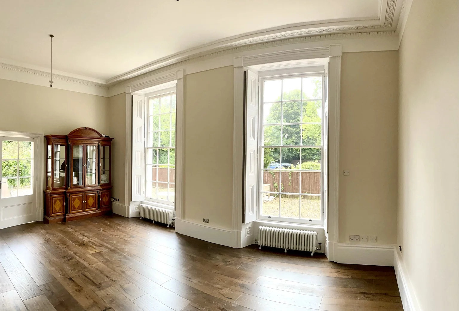 Restored Georgian room near Keynsham with traditional sash windows, ornate cornices and timber flooring