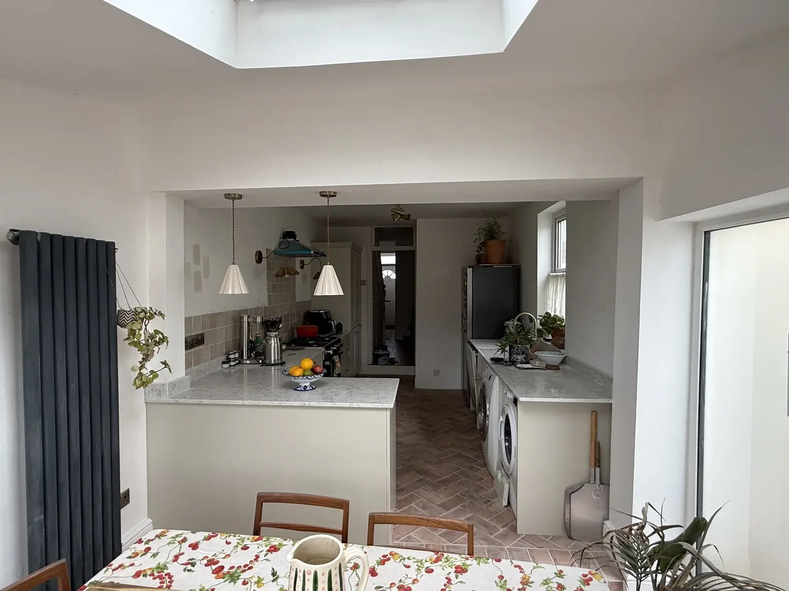 View from the dining space through the wide opening into the kitchen.